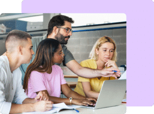 photo of teacher helping high school students on computer