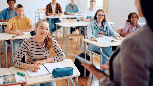 Students looking up attentively with pen and paper